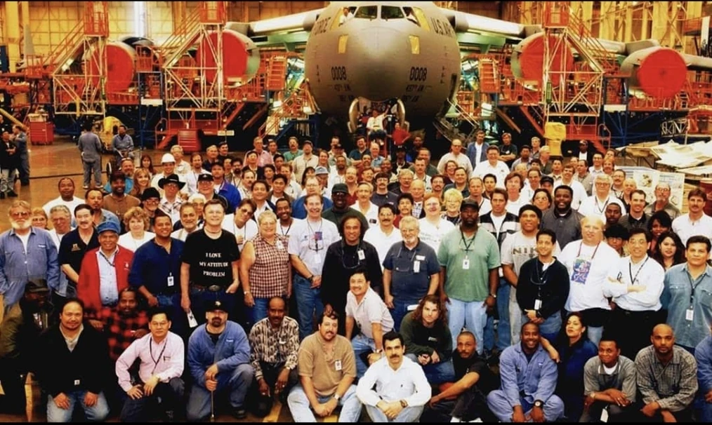 Technicians and engineers who worked on C-17 aircraft 0008 standing in front of the early production aircraft